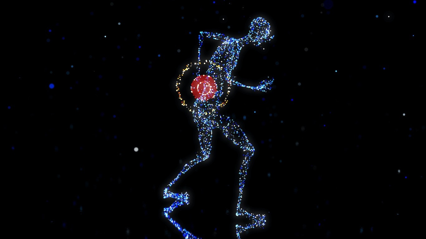 Sinisistä valopisteistä koostuva ihmishahmo pitää kättään alaselällään joka hohkaa pistemäistä punaista valoa.
